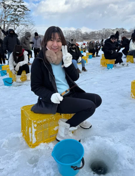 Katherine Leow ice fishing in a snowy setting