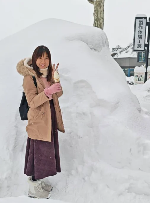 Katherine Leow standing beside a snow-covered scene