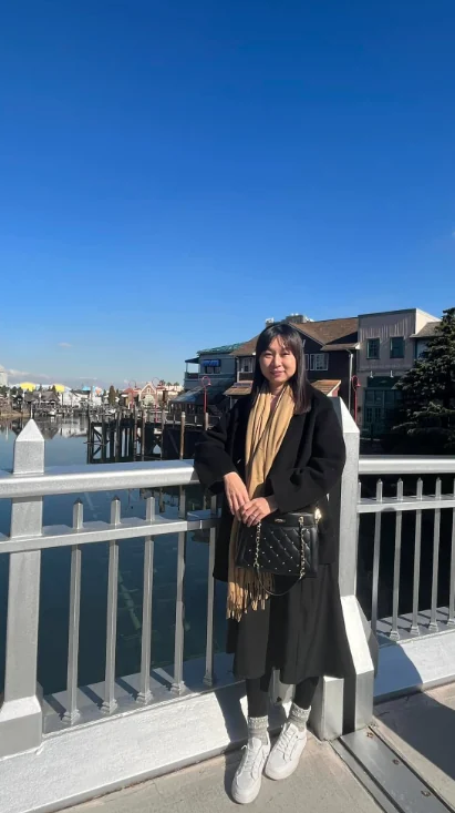 Katherine Leow at a waterfront on a clear day